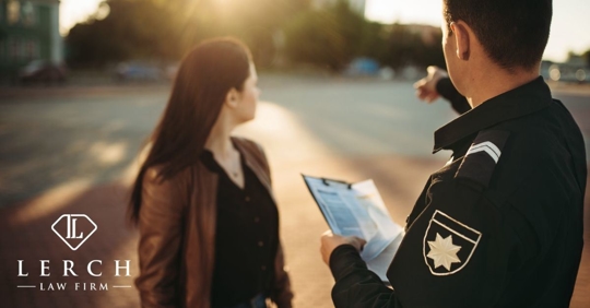 police officer pointing to road to a woman