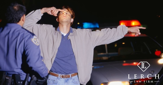 young man taking a field sobriety test at night