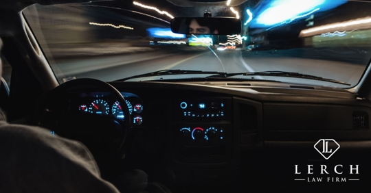 view from inside a car of a road at night with blurry lights